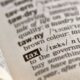 A dictionary opened to the word "tax"